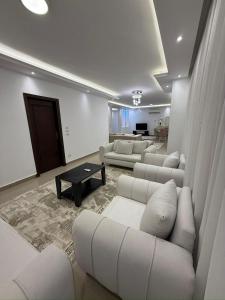 a living room with white couches and a table at Prime Plaza Porto Towers Stay Hotel VIP in Ain Sokhna