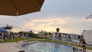 a man standing next to a swimming pool at Casa Real Santa Fe Cuernavaca in Atlacholoaya