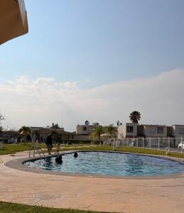 a couple of people playing in a swimming pool at Casa Real Santa Fe Cuernavaca in Atlacholoaya