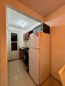 a kitchen with a white refrigerator and a stove at Casa Real Santa Fe Cuernavaca in Atlacholoaya