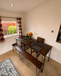 a dining room with a wooden table and a bench at Brae Lodge Dollar in Dollar +1 photo