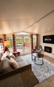 a living room with a couch and a table at Brae Lodge Dollar in Dollar
