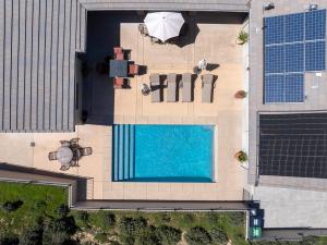 an overhead view of a swimming pool next to a building at Hilltop Vistas Pool, Wine & Family Fun in Atascadero