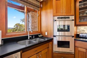 a kitchen with a sink and a window at Hilltop Vistas Pool, Wine & Family Fun in Atascadero