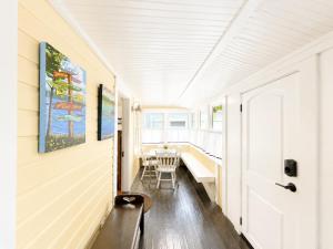 a hallway of a house with a bench and a table at Cottage 8-9 - Stand Alone 2 Bedroom 2 Bath Private Courtyard Pet Friendly with Fee in Wolfeboro +15 photos