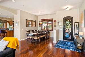 a dining room and living room with a table and chairs at Hilltop Vistas Pool, Wine & Family Fun in Atascadero
