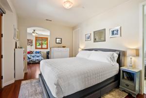 a bedroom with a bed and a living room at Hilltop Vistas Pool, Wine & Family Fun in Atascadero