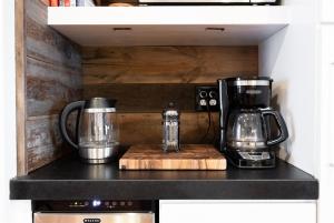 a kitchen counter with a coffee maker and a blender at Templeton Creekside Cottage Walk to Downtown in Templeton +49 photos
