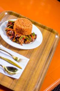 a sandwich on a plate on a glass tray at MORADA HOTELS LTD in Lagos