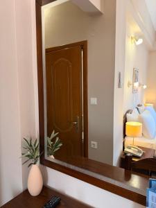 a mirror in a hotel room with a door at Hotel Lemnos in Myrina