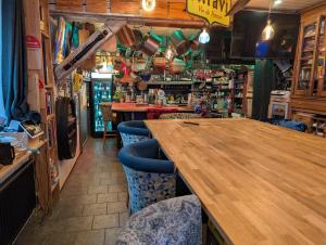 a bar with a wooden table and blue chairs at Hostelry restaurant privé in Écully