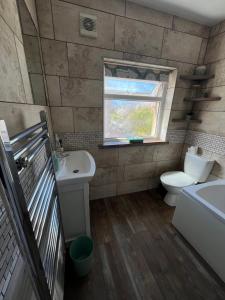 a bathroom with a toilet and a sink and a window at Summer Salt house in Morecambe +17 photos