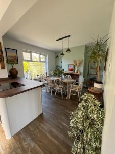 a kitchen and living room with a table and chairs at Summer Salt house in Morecambe