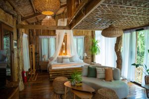 a living room with a bed and a couch at Treehouse de Valentine in Balamban