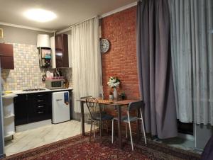a kitchen with a table and chairs in a room at Apartment on 8 Marta in Mykolaiv