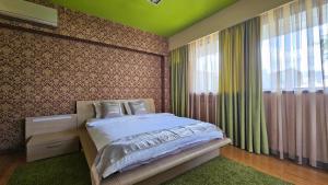 a bedroom with a bed and a large window at SIMPLE BUCHAREST SELF CHECk IN in Bucharest +20 photos