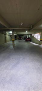 an empty parking garage with cars parked in it at Paris Flats Lagoa Santa in Lagoa Santa