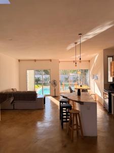 a kitchen and living room with a bed and a table at Pool, Space, Style, Modern House for 8 in Brisas de Zicatela