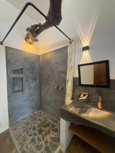 a bathroom with a sink and a mirror at Pool, Space, Style, Modern House for 8 in Brisas de Zicatela +23 photos