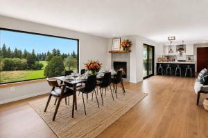 a dining room with a table and chairs and a fireplace at Jade's View Estate in McMinnville