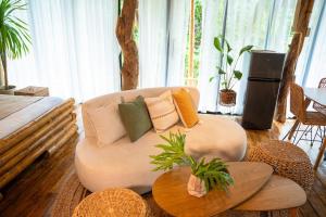 a living room with a couch with pillows on it at Treehouse de Valentine in Balamban