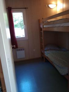 a bedroom with two bunk beds and a window at Adapted chalet in La Chapelle-Taillefert +9 photos