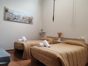 a room with three beds with brown blankets at O Solpor Fillobal in Vilar