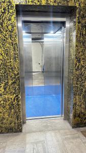 a glass door of an empty subway train at Femina Residency in Kumbakonam