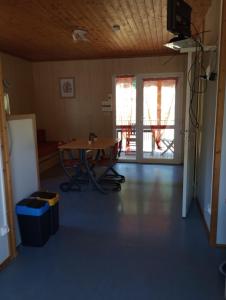 an empty room with a table and a window at Adapted chalet in La Chapelle-Taillefert