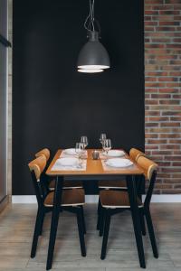 a dining room table with chairs and aendant light at Apartament Centrum Żywiec - PILSKO in Żywiec