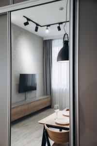 a dining room with a table and a tv at Apartament Centrum Żywiec - PILSKO in Żywiec