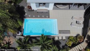 an overhead view of a swimming pool at a resort at Villa Coco Cannelle in Deshaies +5 photos
