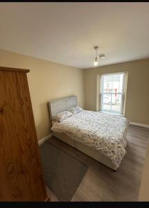 a bedroom with a bed and a window at Sperrin Way Apartment in Newtownstewart