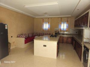 a large kitchen with a couch in a room at Villa du bonheur Chambres d'hote in Ouled el guerne