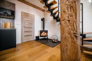 a living room with a fireplace and a staircase at Turistka Loft in Kutná Hora