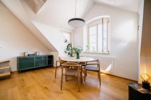 a dining room with a table and chairs at Turistka Loft in Kutná Hora