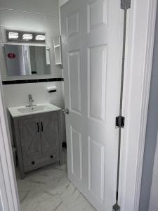 a bathroom with a white door and a sink at Cape View Motel & Cottages in Mavillette +23 photos