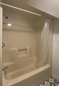 a bathroom with a bath tub with a shower curtain at Sleeping Sailor in Camden