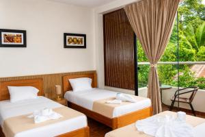 two beds in a room with a window at Fanda in Sauce +64 photos