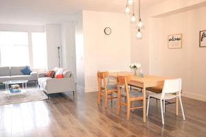 a dining room and living room with a table and chairs at Modern 3 bedroom duplex home in Langley in Langley +36 photos