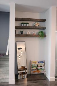 a hallway with a mirror and a mirror shelf at Modern 3 bedroom duplex home in Langley in Langley