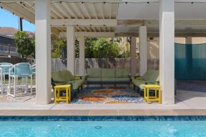a patio with chairs and a swimming pool at House of Neptune Steps from the sea and private pool in South Padre Island