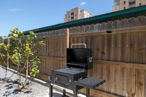 a laptop sitting on a table next to a fence at House of Neptune Steps from the sea and private pool in South Padre Island +28 photos