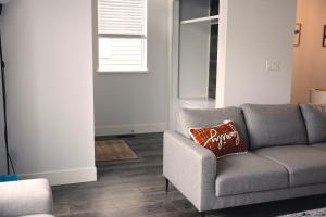 a living room with a gray couch and a window at Modern 3 bedroom duplex home in Langley in Langley