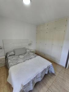 a white bedroom with a bed and white cabinets at Santa Úrsula 66 in Costa Calma