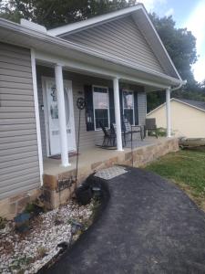 a house with a front porch with a patio at Lil ranch in White Pine