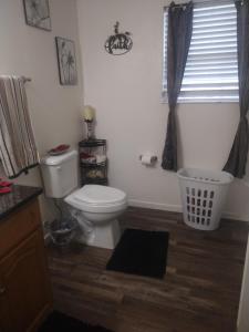 a bathroom with a toilet and a window at Lil ranch in White Pine