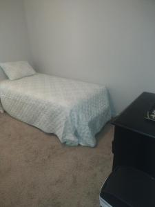 a small bed in a room with a night stand at Lil ranch in White Pine