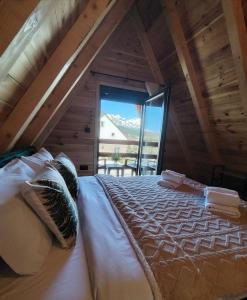 a bedroom with a large bed in a attic at Durmitor sky in Žabljak +43 photos
