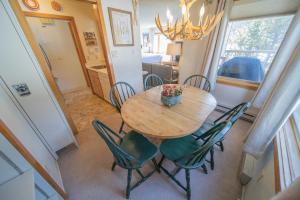 a dining room with a wooden table and chairs at Lenawee 1728 by SummitCove Lodging in Colorado in Keystone
